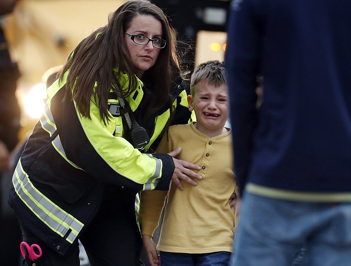 Officials guide students off a bus and into a recreation center where they were reunited with their parents after a shooting at a suburban Denver middle school Tuesday, May 7, 2019, in Highlands Ranch, Colo. (David Zalubowski/AP)
