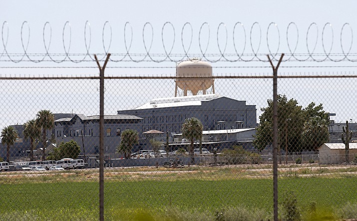 This July 23, 2014, file photo shows a state prison in Florence. The Arizona Department of Corrections has started transferring inmates from parts of a Phoenix-area state prison where a union representing guards says problems with cell door locks led to an inmate's death and the severe beating of two guards. (AP photo, file)