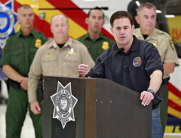 Gov. Doug Ducey speaks to the press July 11, 2018, at the Department of Public Safety aircraft hangar in Phoenix. At the time, Ducey expressed confidence in Corrections Director Charles Ryan after the prisons chief was found in civil contempt of court for failing to adequately improve health care for inmates. A judge overseeing a legal settlement over the quality of health care in Arizona's prisons has threatened Monday, May 6, 2019, to impose as much as $1.7 million in additional contempt-of-court fines against the state for failing to adequately improve inmate care. (Matt York/AP, file)