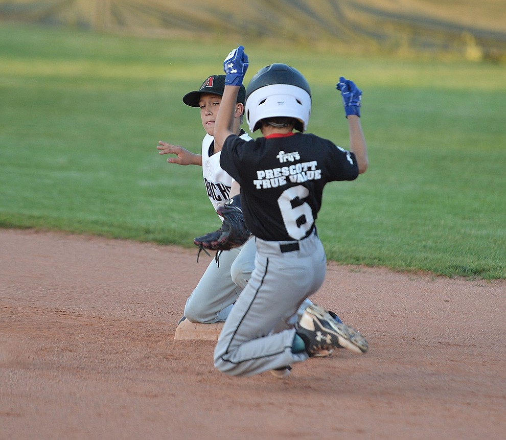 Taylor Keppel tries to make the tag on Caden Bernier during the Prescott Little League majors City Championship semi-final game Tuesday, May 14. (Les Stukenberg/Courier)