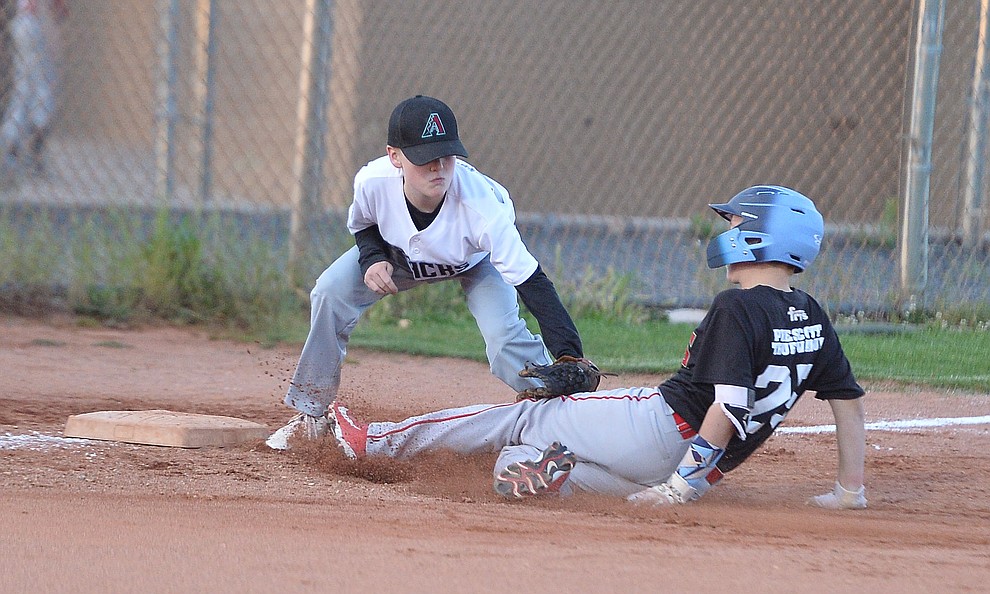 Carter Cashatt tags Adrin Sanderford out at third during the Prescott Little League majors City Championship semi-final game Tuesday, May 14. (Les Stukenberg/Courier)