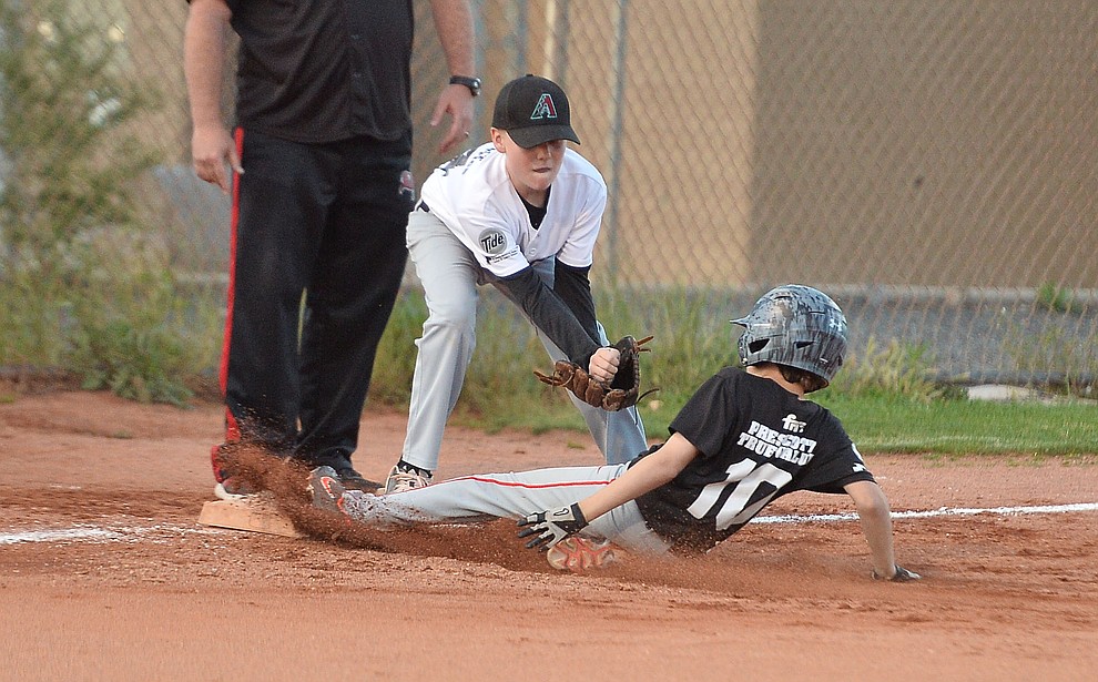 Mike Falick slides safely into third under the tag of Carter Cashatt during the Prescott Little League majors City Championship semi-final game Tuesday, May 14. (Les Stukenberg/Courier)