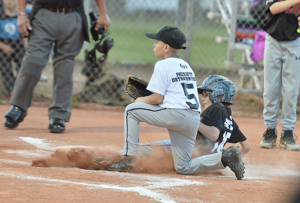 Mike Falick slides safely home under Trace Overton during the Prescott Little League majors City Championship semi-final game Tuesday, May 14. (Les Stukenberg/Courier)