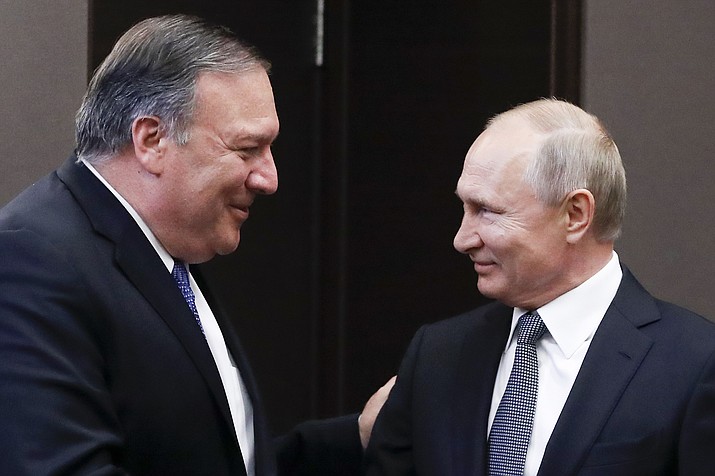Russian President Vladimir Putin, right, and U.S. Secretary of State Mike Pompeo, greet each other prior to their talks in the Black Sea resort city of Sochi, southern Russia, Tuesday, May 14, 2019. Pompeo arrived in Russia for talks that are expected to focus on an array of issues including arms control and Iran. (Pavel Golovkin/AP, Pool)