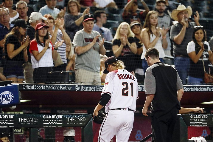 Arizona Diamondbacks starting pitcher Zack Greinke leaves the field with a trainer during the eighth inning of a baseball game against the Pittsburgh Pirates in Phoenix, Wednesday, May 15, 2019. (Matt York/AP)