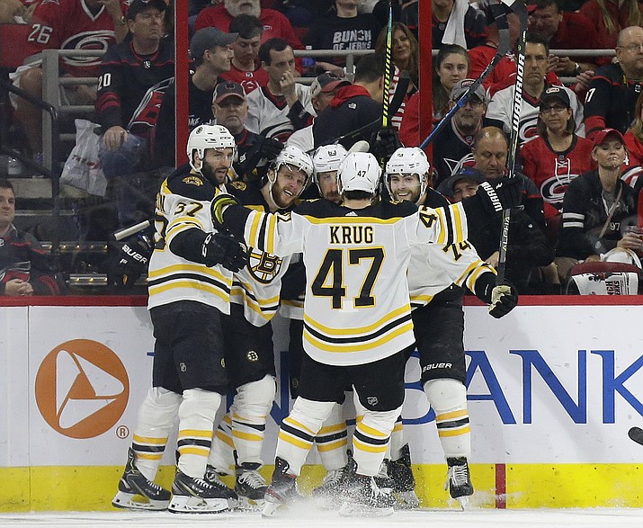 Boston Bruins’ Patrice Bergeron (37) David Pastrnak, second from left, Brad Marchand (63), Jake DeBrusk (74) and Torey Krug (47) celebrate Pastrnak’s goal against the Carolina Hurricanes during the second period in Game 4 of the Stanley Cup Eastern Conference finals in Raleigh, N.C., Thursday, May 16, 2019. (Gerry Broome/AP)
