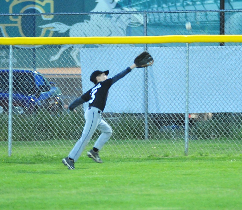 Ryan Crandall just misses a deep fly ball as Farmers Insurance faced off against the True Vaue in the Prescott Little League Majors City Championship Game Friday, May 17. (Les Stukenberg/Courier)