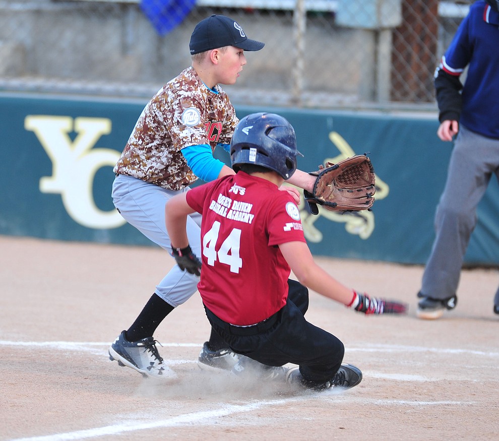 Quinton Del Prata scores the game winning run on Pace Norman as the Grand Highland Cobras faced off against the Process Driven Baseball Diamondbacks in the Prescott Little League Minors City Championship Game Friday, May 17.  (Les Stukenberg/Courier)