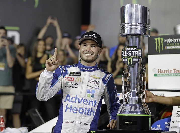 Kyle Larson poses with the trophy after winning the NASCAR All-Star Race at Charlotte Motor Speedway in Concord, N.C., Saturday, May 18, 2019. (Chuck Burton/AP)