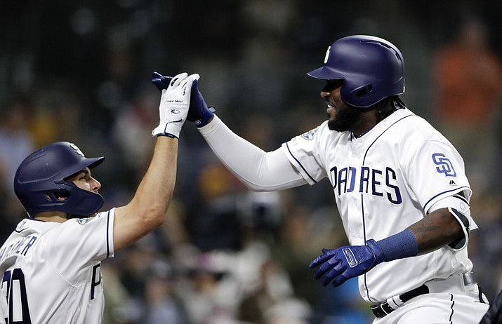 San Diego Padres’ Franmil Reyes, right, celebrates with teammate Eric Hosmer, left, after hitting a two-run home run during the sixth inning of a baseball game against the Arizona Diamondbacks, Monday, May 20, 2019, in San Diego. (Gregory Bull/AP)