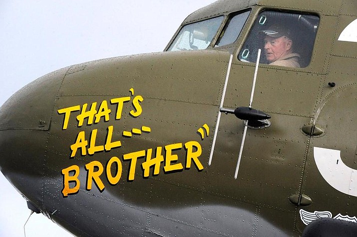 In this April 9, 2019, photo, Pilot Tom Travis sits in the cockpit of the World War II troop carrier That's All, Brother during a stop in Birmingham, Ala. The C-47 aircraft, which led the main Allied invasion of Europe on June 6, 1944, is returning to the continent to participate in events marking the 75th anniversary of D-Day in June. (AP Photo/Jay Reeves)