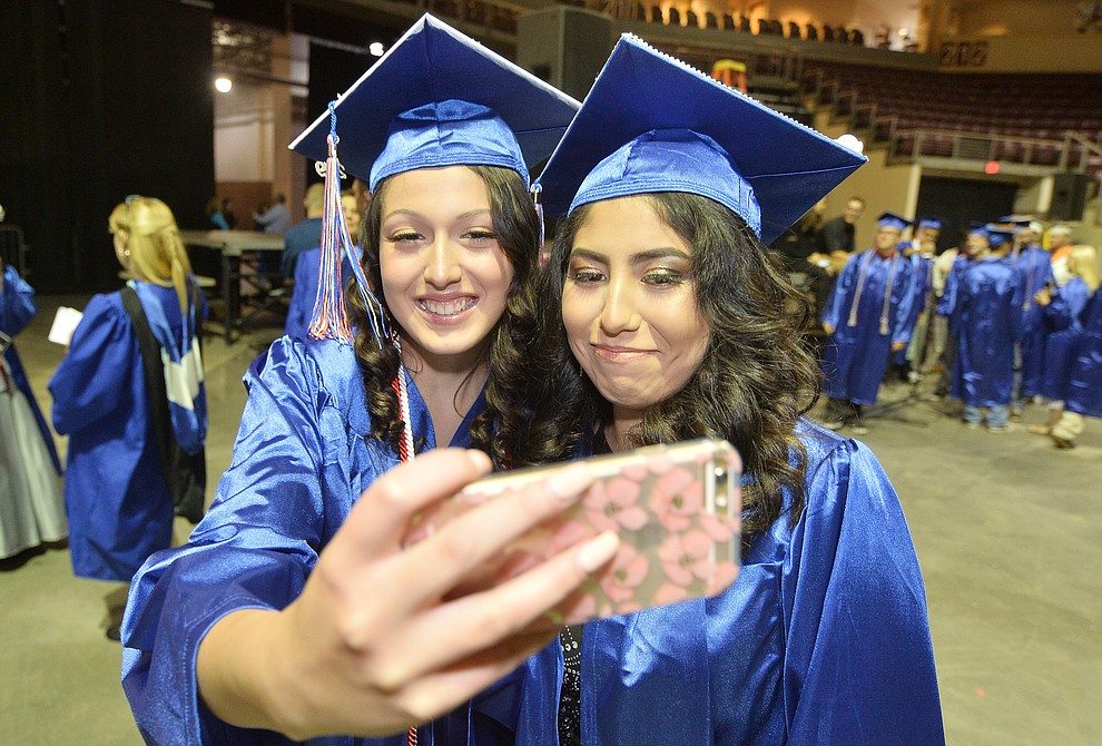 Olivia Robertson and Xadani Millan take a selfie before Chino Valley HIgh School graduated 153 students in a commencement ceremony Wednesday, May 22 at the Findlay Toyota Center in Prescott Valley. (Les Stukenberg/Courier)