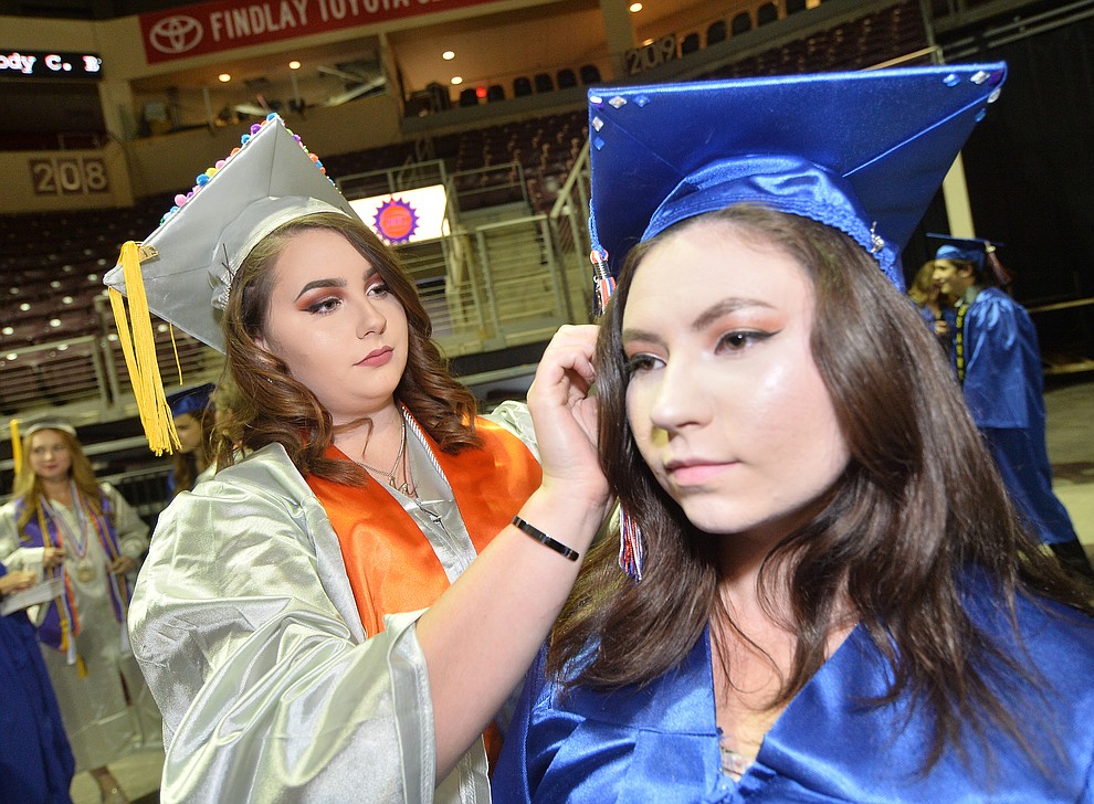 Madisen Scott adjusts Michaela Scott's mortar board before Chino Valley HIgh School graduated 153 students in a commencement ceremony Wednesday, May 22 at the Findlay Toyota Center in Prescott Valley. (Les Stukenberg/Courier)