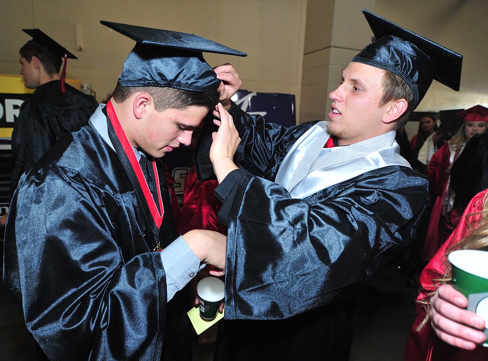 Luke Huenemeyer helps Parker Hines before Bradshaw Mountain High School graduated 334 students in a commencement ceremony Thursday, May 23 at the Findlay Toyota Center in Prescott Valley. (Les Stukenberg/Courier)
