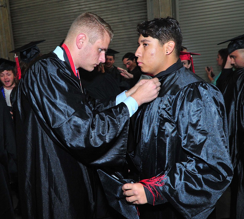 Owen Mayotte helps Michale Villa before Bradshaw Mountain High School graduated 334 students in a commencement ceremony Thursday, May 23 at the Findlay Toyota Center in Prescott Valley. (Les Stukenberg/Courier)