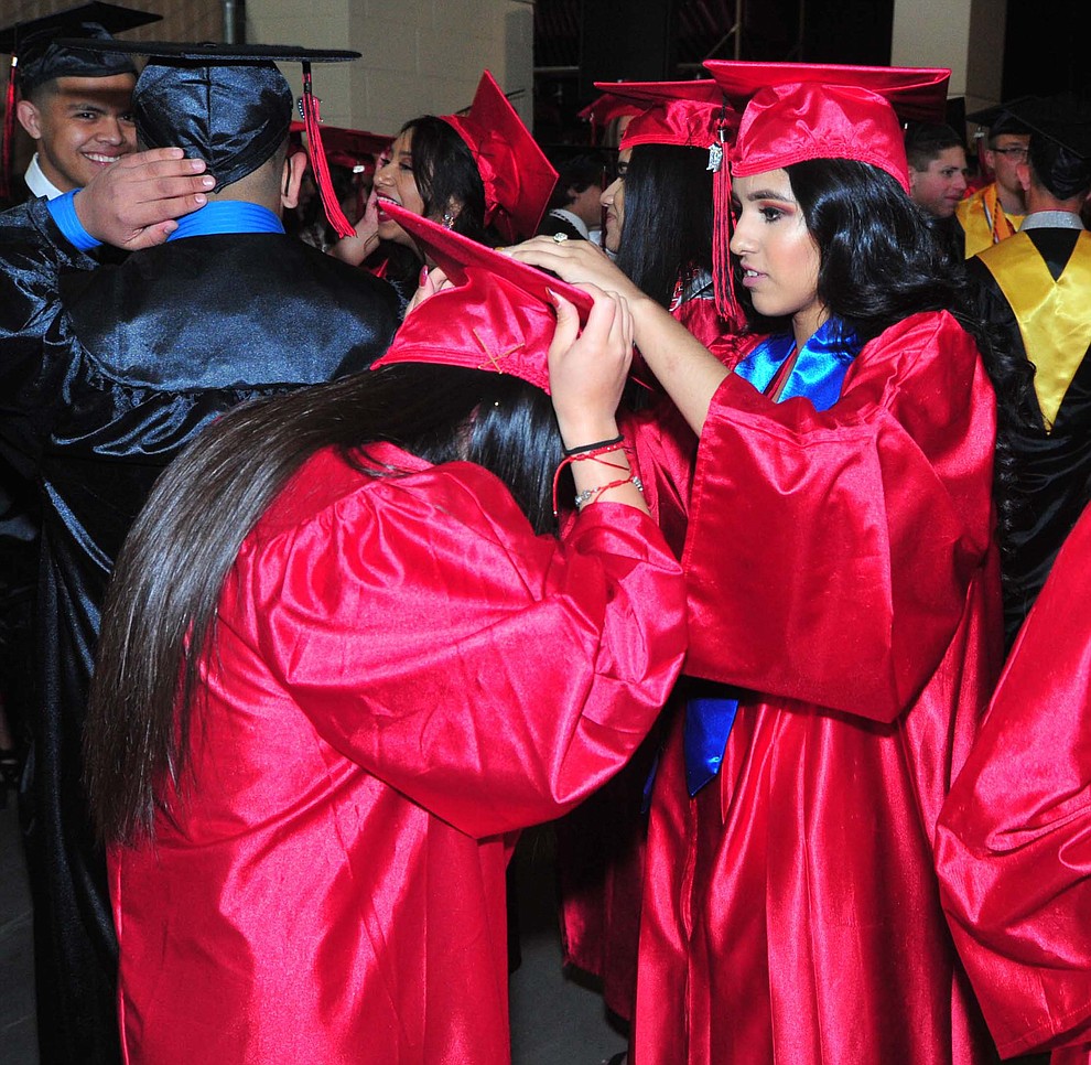 Jocelyn Carino helps Lizette Jasso Mendoza Bradshaw Mountain High School graduated 334 students in a commencement ceremony Thursday, May 23 at the Findlay Toyota Center in Prescott Valley. (Les Stukenberg/Courier)