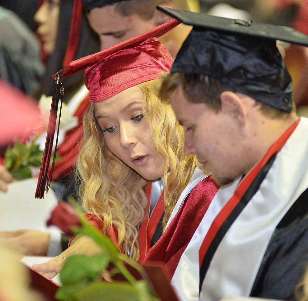 Graduates look at what's actually in their diploma holder as Bradshaw Mountain High School graduated 334 students in a commencement ceremony Thursday, May 23 at the Findlay Toyota Center in Prescott Valley. (Les Stukenberg/Courier)