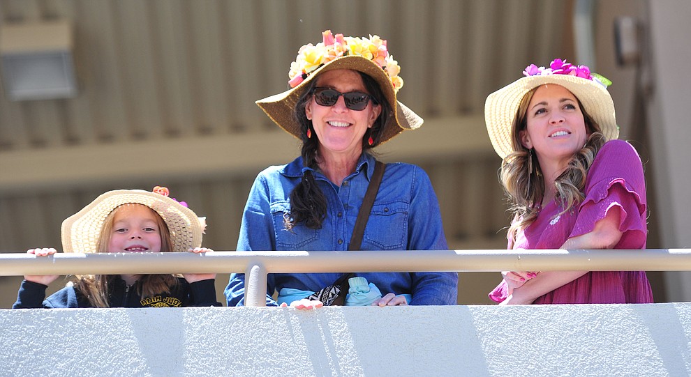 Brynlee Smith, Kathy Vallely and Mattie Smith don their best headwear for opening day of Arizona Downs Friday, May 24 in Prescott Valley. The racetrack reopens under new ownership after being closed for 10 years. (Les Stukenberg/Courier)