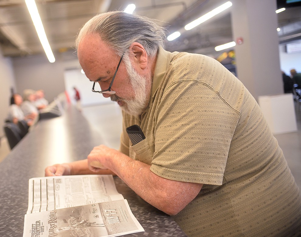 Michael McGranahan studies the horses in today's races at opening day of Arizona Downs Friday, May 24 in Prescott Valley. The racetrack reopens under new ownership after being closed for 10 years. (Les Stukenberg/Courier)