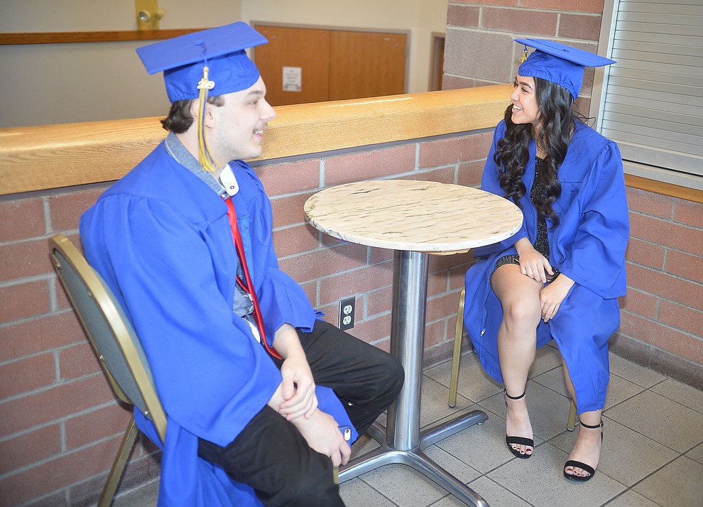 Dillon Music and Arieanna Golden relax before Prescott High School graduated 301 students in a commencement ceremony Friday, May 24 on Bill Shepard Field in Prescott. (Les Stukenberg/Courier)