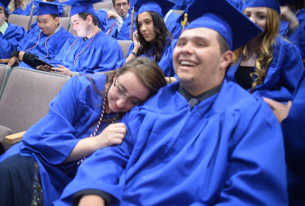 KhiernanDevault-Harrell rests her head on Robert Oldfield's shoulder before Prescott High School graduated 301 students in a commencement ceremony Friday, May 24 on Bill Shepard Field in Prescott. (Les Stukenberg/Courier)