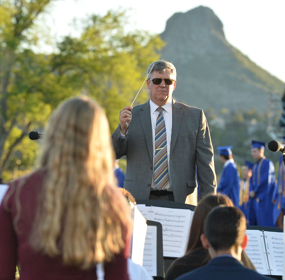 Dan Bradstreet conducts the concert band as Prescott High School graduated 301 students in a commencement ceremony Friday, May 24 on Bill Shepard Field in Prescott. (Les Stukenberg/Courier)