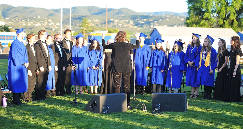 The Prescott High School Chamber Singers sing the National Anthem as Prescott High School graduated 301 students in a commencement ceremony Friday, May 24 on Bill Shepard Field in Prescott. (Les Stukenberg/Courier)