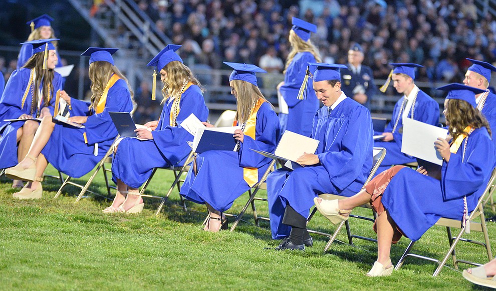 Students get their first glance at their diploma as Prescott High School graduated 301 students in a commencement ceremony Friday, May 24 on Bill Shepard Field in Prescott. (Les Stukenberg/Courier)
