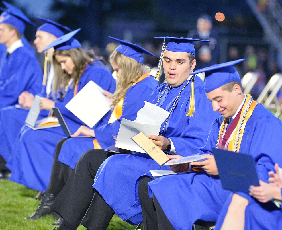 Students get their first glance at their diploma as Prescott High School graduated 301 students in a commencement ceremony Friday, May 24 on Bill Shepard Field in Prescott. (Les Stukenberg/Courier)