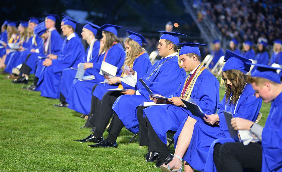 Students get their first glance at their diploma as Prescott High School graduated 301 students in a commencement ceremony Friday, May 24 on Bill Shepard Field in Prescott. (Les Stukenberg/Courier)
