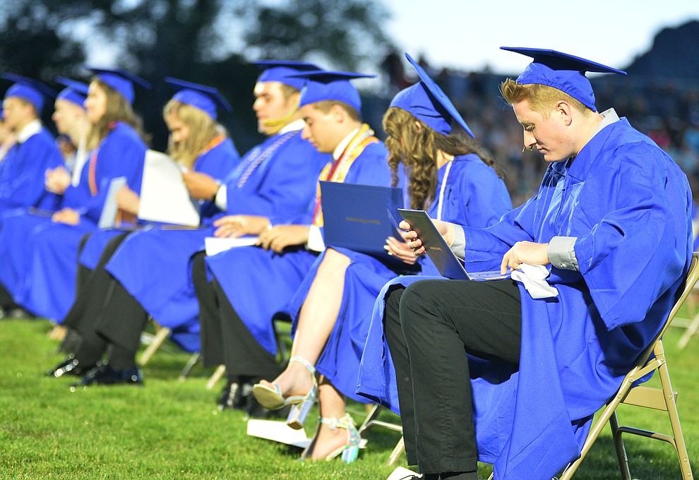 Students get their first glance at their diploma as Prescott High School graduated 301 students in a commencement ceremony Friday, May 24 on Bill Shepard Field in Prescott. (Les Stukenberg/Courier)