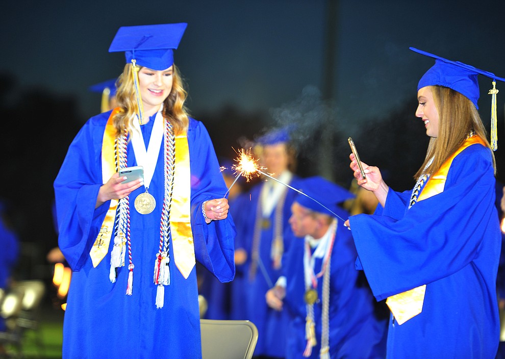 Students light sparklers as Prescott High School graduated 301 students in a commencement ceremony Friday, May 24 on Bill Shepard Field in Prescott. (Les Stukenberg/Courier)