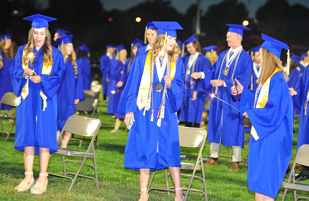 Students light sparklers as Prescott High School graduated 301 students in a commencement ceremony Friday, May 24 on Bill Shepard Field in Prescott. (Les Stukenberg/Courier)