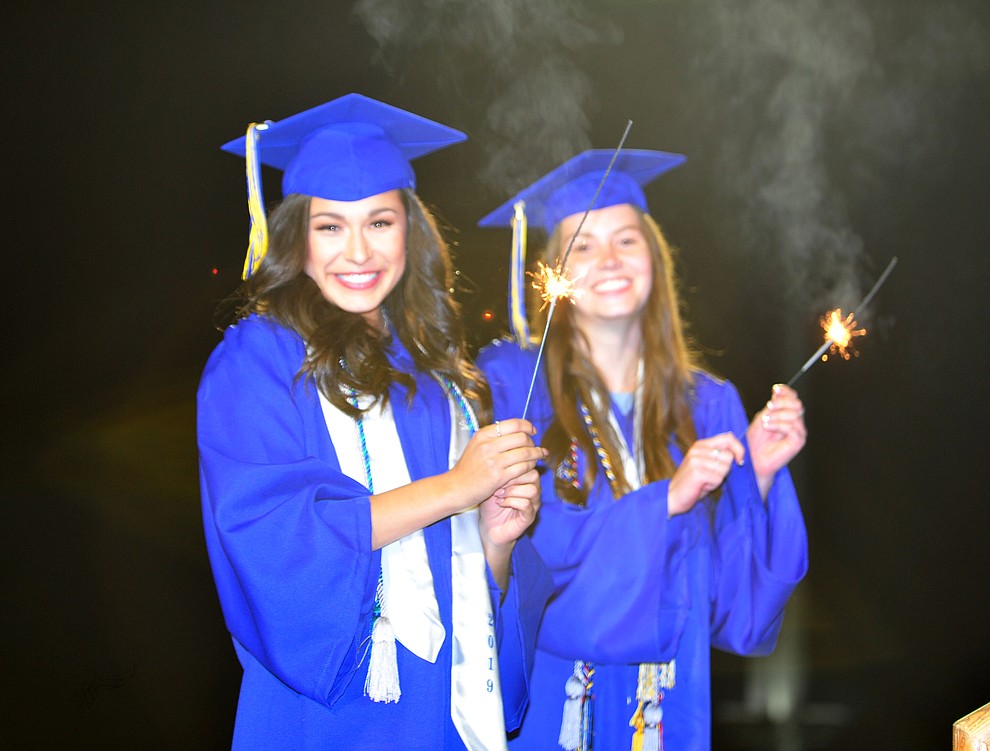 Taylor Lopez and Dani Dreher with their sparklers as Prescott High School graduated 301 students in a commencement ceremony Friday, May 24 on Bill Shepard Field in Prescott. (Les Stukenberg/Courier)