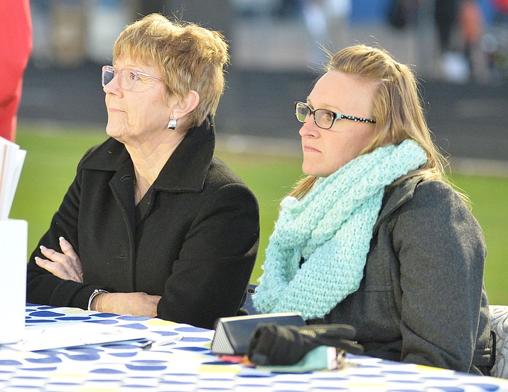 Birdie Ferra and Meghan Anderson try to stay warm as Prescott High School graduated 301 students in a commencement ceremony Friday, May 24 on Bill Shepard Field in Prescott. (Les Stukenberg/Courier)
