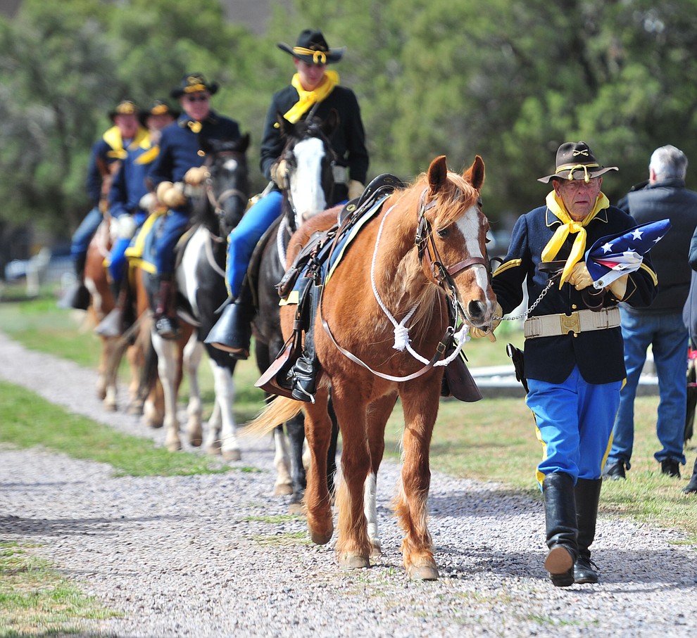 The Camp Verde Cavalry brings the United States flag to be raised during the Memorial Day Ceremony at the Citizens Cemetery Monday, May 27 in Prescott. (Les Stukenberg/Courier)