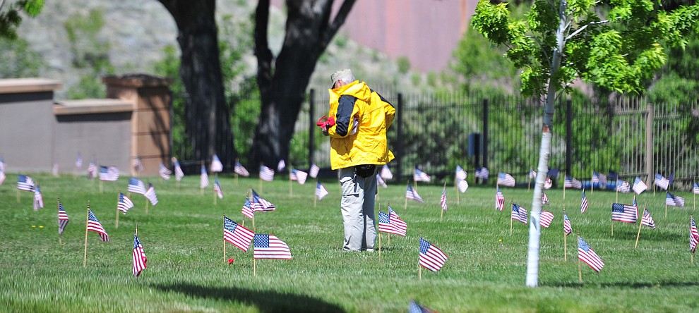 John Bostwick looks at the grave of a British soldier before the Memorial Day Ceremony at the National Cemetery Monday, May 27 in Prescott. (Les Stukenberg/Courier)