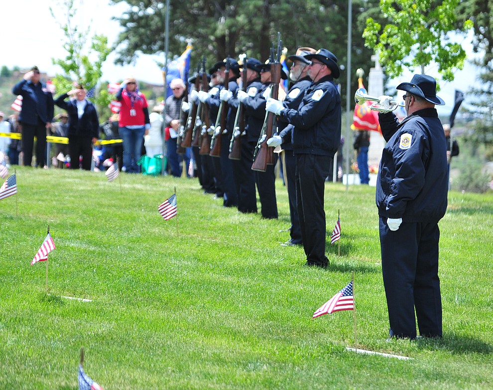 US Army veteran Brad Moors plays taps during the Memorial Day Ceremony at the National Cemetery Monday, May 27 in Prescott. (Les Stukenberg/Courier)