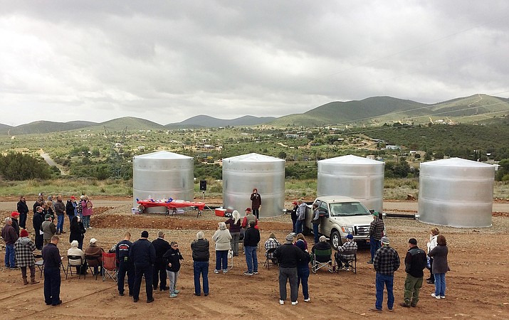 Dewey-Humboldt residents and personnel from the Prescott Area Wildland Urban Interface Commission, Firewise sites, fire departments and county officials attend the dedication of four new water storage tanks in the Blue Hills section of town on a blustery May 22, 2019. (CAFMA/Courtesy)