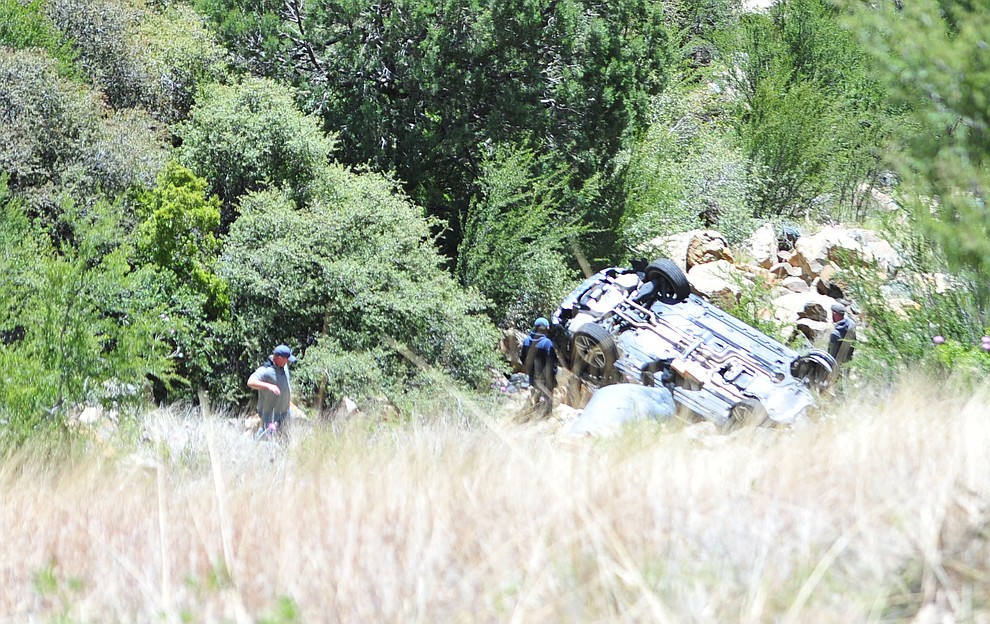 Arizona Department of Public Safety (DPS) investigators are on the scene where a stolen vehicle was run off a cliff at mile marker 303 on Highway 89 Monday, May 28 between Prescott and Wilhoit. The vehicle is approximately 500 feet down a steep hillside, landing in a drainage. (Les Stukenberg/Courier)