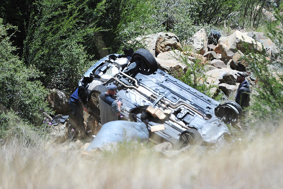 Arizona Department of Public Safety (DPS) investigators are on the scene where a stolen vehicle was run off a cliff at mile marker 303 on Highway 89 Monday, May 28 between Prescott and Wilhoit. The vehicle is approximately 500 feet down a steep hillside, landing in a drainage. (Les Stukenberg/Courier)