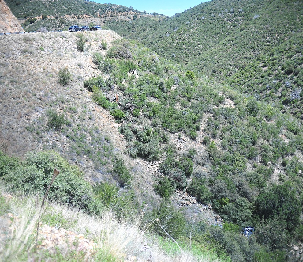 Arizona Department of Public Safety (DPS) investigators are on the scene where a stolen vehicle was run off a cliff at mile marker 303 on Highway 89 Monday, May 28 between Prescott and Wilhoit. The vehicle is approximately 500 feet down a steep hillside, landing in a drainage. (Les Stukenberg/Courier)