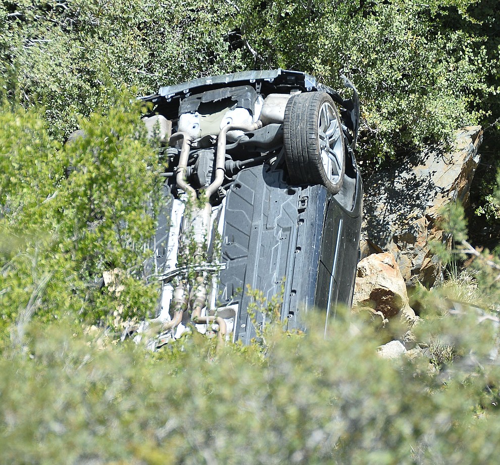 Arizona Department of Public Safety (DPS) investigators are on the scene where a stolen vehicle was run off a cliff at mile marker 303 on Highway 89 Monday, May 28 between Prescott and Wilhoit. The vehicle is approximately 500 feet down a steep hillside, landing in a drainage. (Les Stukenberg/Courier)