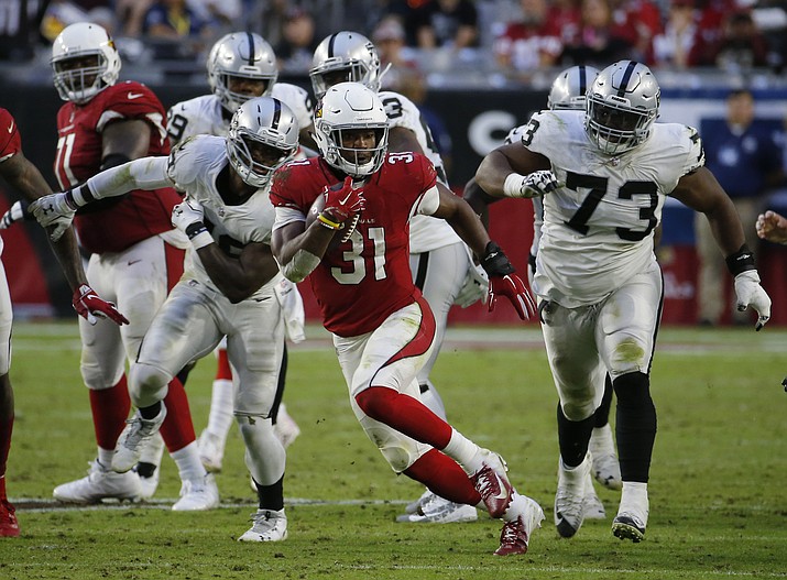 In this Nov. 18, 2018, photo, Arizona Cardinals running back David Johnson (31) carries during the NFL football team’s game against the Oakland Raiders in Glendale, Ariz. Johnson came close to having 1,000 yards rushing and receiving once before and believes he can do it under new coach Kliff Kingsbury s high-octane offense. (Rick Scuteri/AP, File)