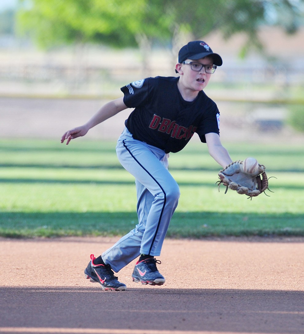 Prescott's Mike Falick fields the ball at third against Prescott Valley at the Little League Tournament of Champions in Chino Valley Saturday May 31. (Les Stukenberg/Courier)