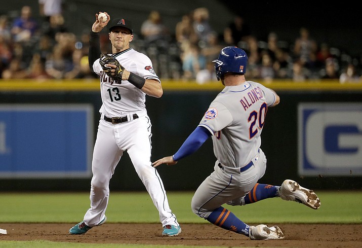 Arizona Diamondbacks' Nick Ahmed forces out New York Mets Pete Alonso as he turns a double play on Michael Conforto during the third inning Friday, May 31, 2019, in Phoenix. (Matt York/AP)