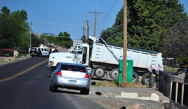 A dump truck sits on the side of the road near Loos Drive between Minor and Robert roads after hitting a power line and causing a power outage Tuesday, June 4, 2019, in Prescott Valley. (Les Stukenberg/Courier)
