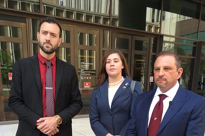 In this March 29, 2018 file photo, 32-year-old Tahnee Gonzales of Glendale, Arizona, stands next to her attorneys Marc Victor, right, and Andrew Marcantel, left, outside of the courthouse in Phoenix. Gonzales, who was captured on video making derogatory comments about Muslims as she and a friend took Qurans and other items from an Arizona mosque, was sentenced Tuesday, June 4, 2019 to two years of probation for her aggravated criminal damage conviction. . (AP Photo/Jacques Billeaud, File)