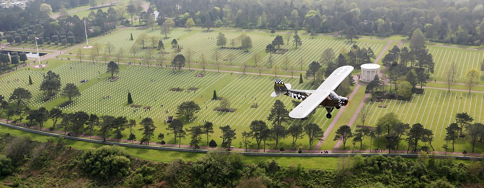 A Piper Cub with French Resistance hero Roland LePers flies over the cemetery above Omaha Beach during a 2009 tour of the Normandie region of France. (Bill Morrison/Courtesy photo)