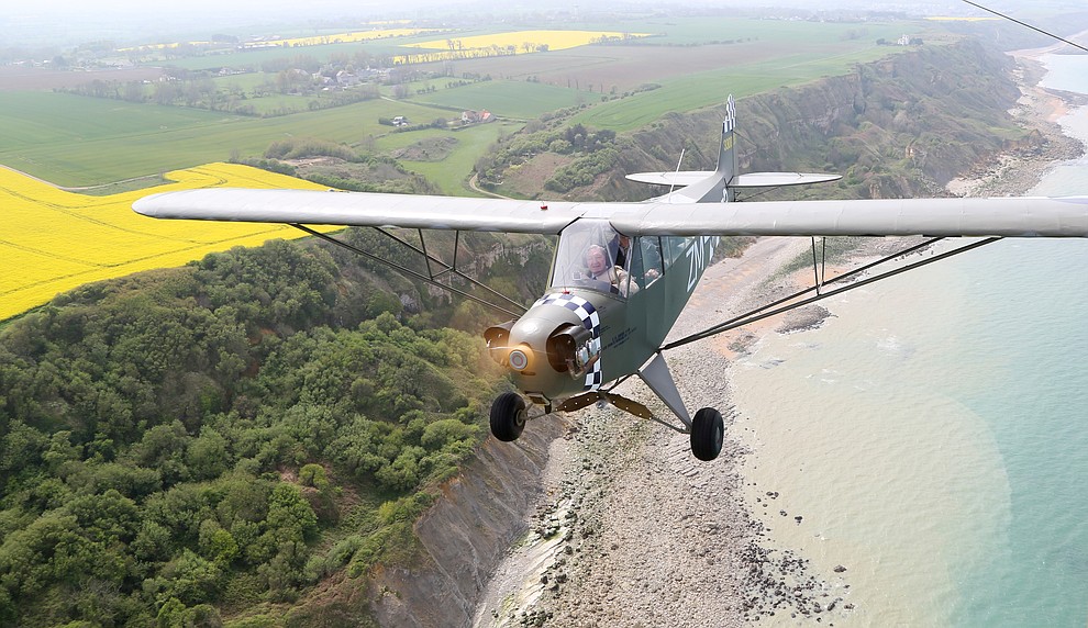 A Piper Cub with French Resistance hero Roland LePers flies over the beaches of Normandie during a 2009 tour of the Normandie region of France. (Bill Morrison/Courtesy photo)